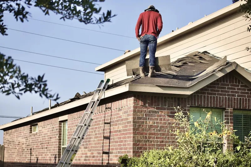 Professional roofer working on a residential roof in Quail Ridge
